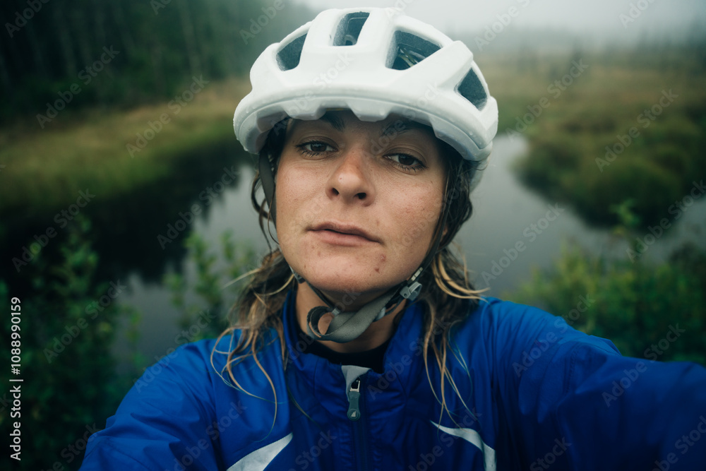 cyclist in a white helmet takes a selfie and smiles. cyclist in a white helmet takes a selfie and smiles.