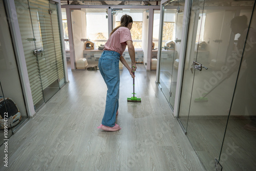 Personnel utilize mops to clean floors, ensuring clean and safe environment for cats. Hygiene, antibacterial dusting in animal accommodation area, consistent floor wash in pet hotel for best service photo