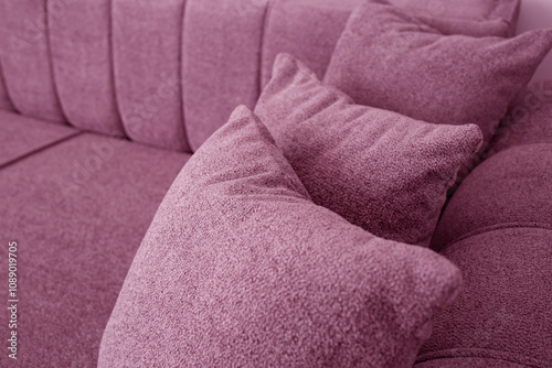 Pink couch detail with three pillows, cloae up photo