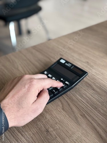 a person doing math on a calculator by hand 