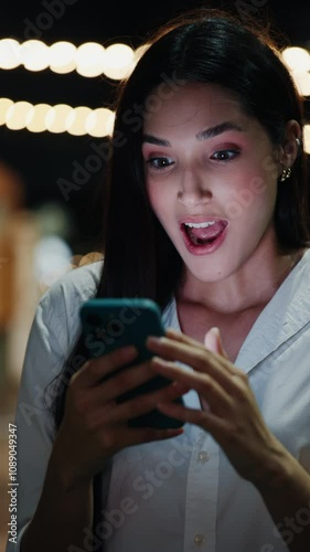 Vertical Video. Young Girl Celebrates An Online Prize She Won Through Her Phone. Hooray The Woman Received An SMS About A New Work Project And Is Celebrating The News. People and Technology Concept