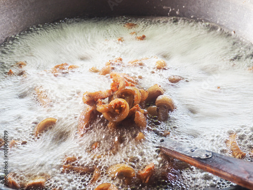 boiling oil to cooking pork wile deep fired crispy photo