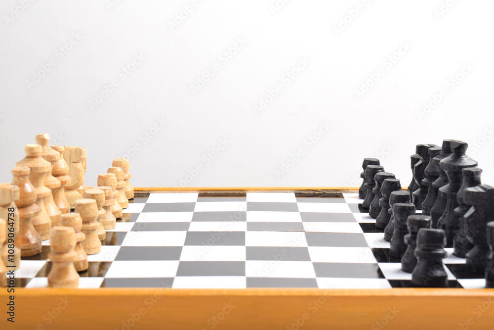 Two chess teams, Chess Game Setup, Starting Formation on chess board. Isolated on white background Two chess teams, Chess Game Setup, Starting Formation on chess board. Isolated on white background