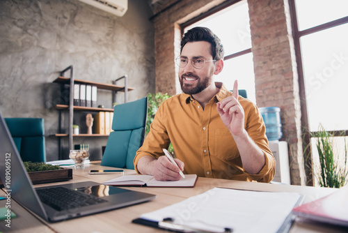 Photo of handsome young guy video call working dressed yellow shirt formalwear comfortable startup office loft room interior photo