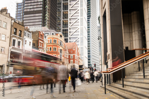 London city street scene with financial buildings and motion blurred people photo