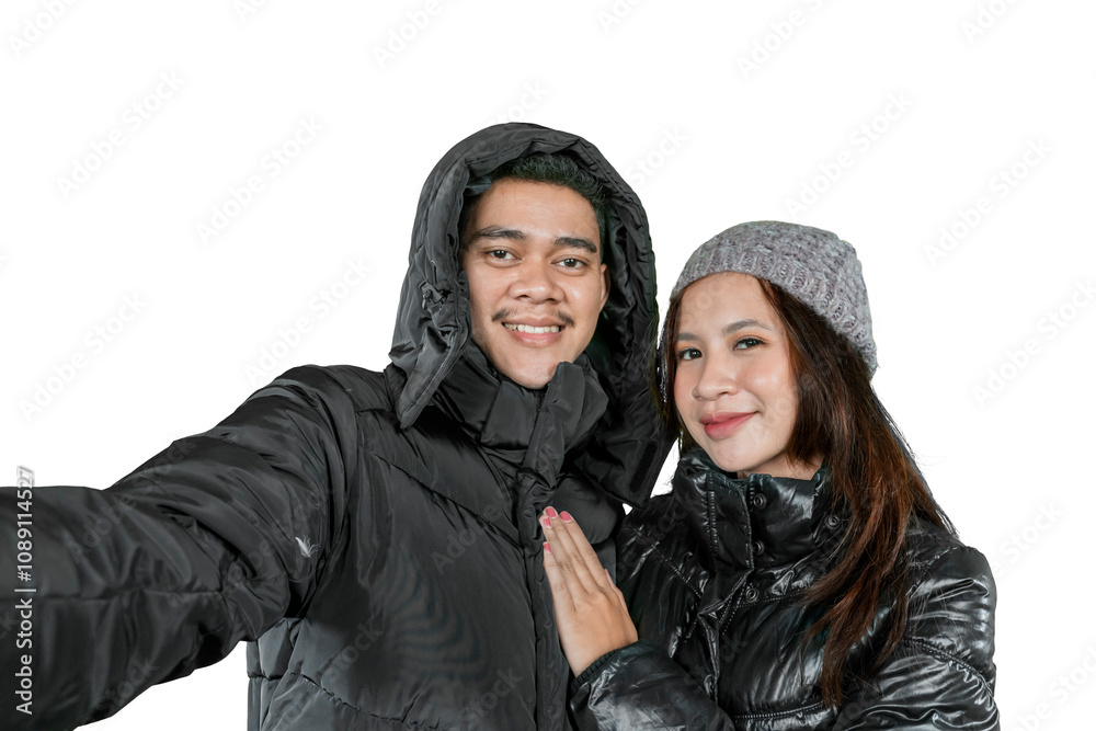 Happy Couple in Warm Winter Jackets Taking a Selfie Happy Couple in Warm Winter Jackets Taking a Selfie