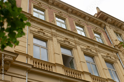 This stunning, historically significant building features exquisite architecture, large windows, and charming balconies, set amidst lush greenery that enhances its allure as a notable city landmark