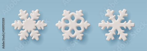 3D illustration of a set of white snowflakes of different shapes on an isolated blue background.