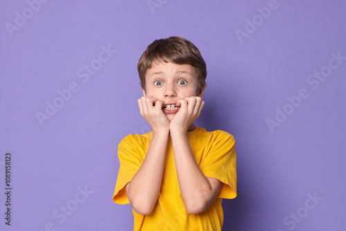 Canvas-taulu Portrait of scared little boy on violet background