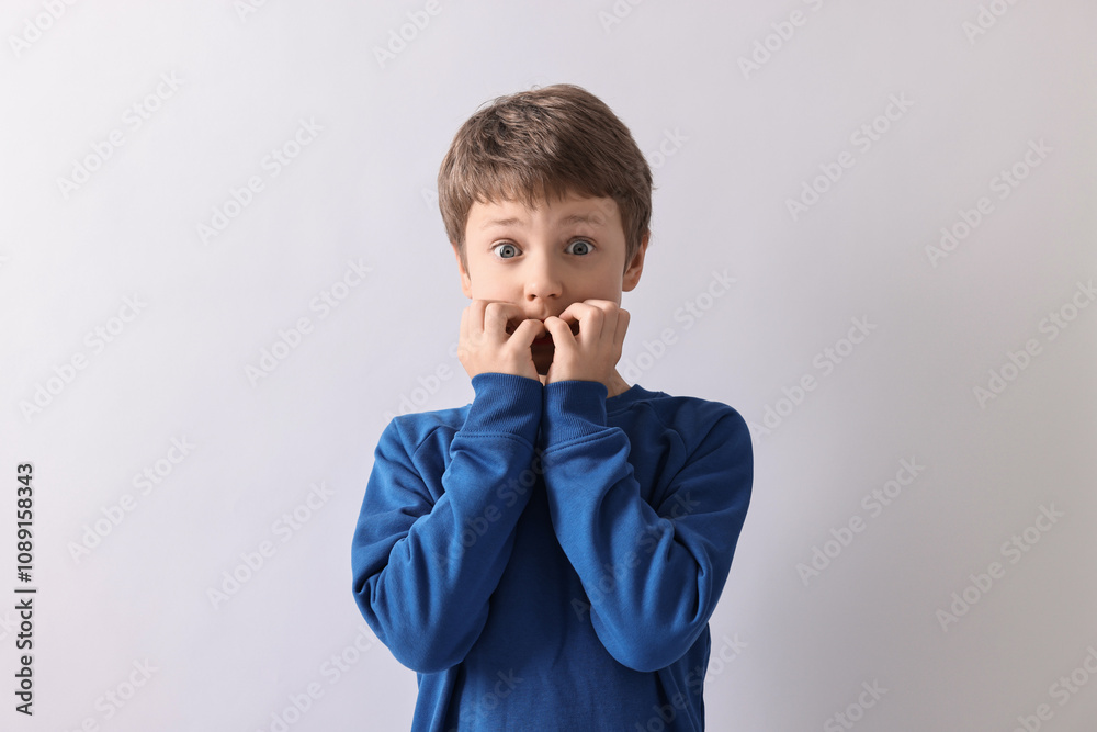 Portrait of scared little boy on light background Portrait of scared little boy on light background