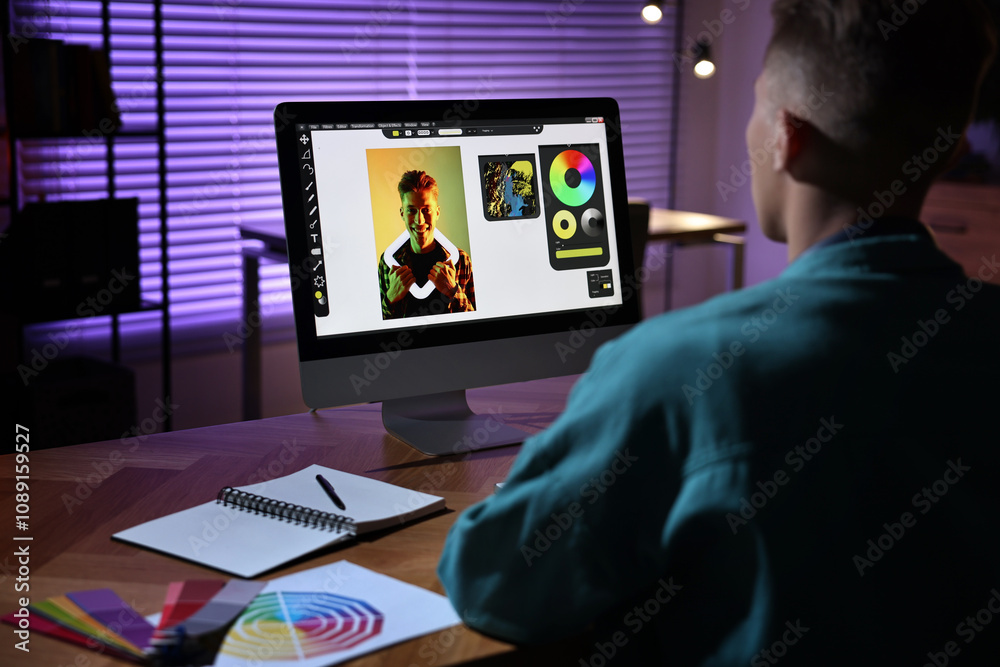 Designer working on computer indoors at night Designer working on computer indoors at night
