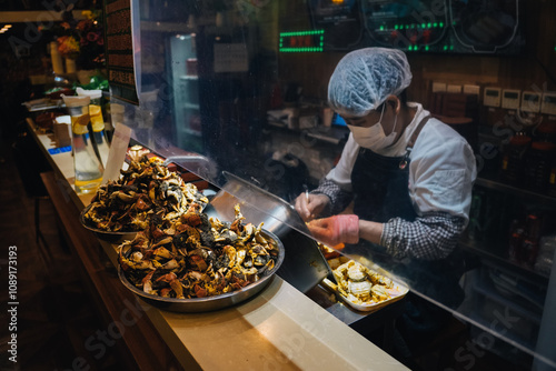 Photography Unrecognizable Chinese person peeling boiled crab meat in restaurant to prepare