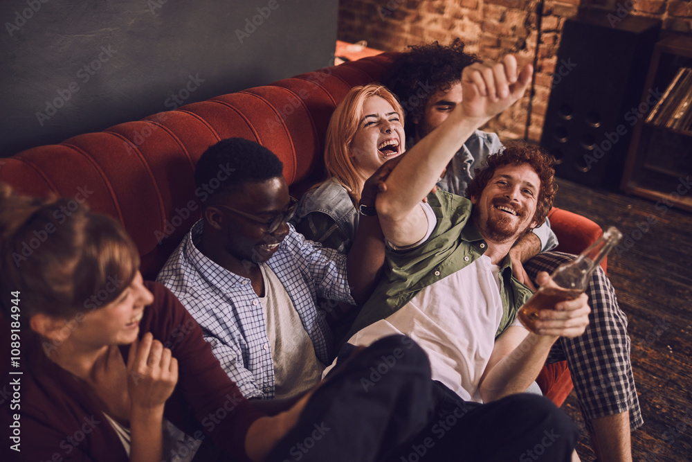 Friends laughing and having fun on a couch at a bar Friends laughing and having fun on a couch at a bar