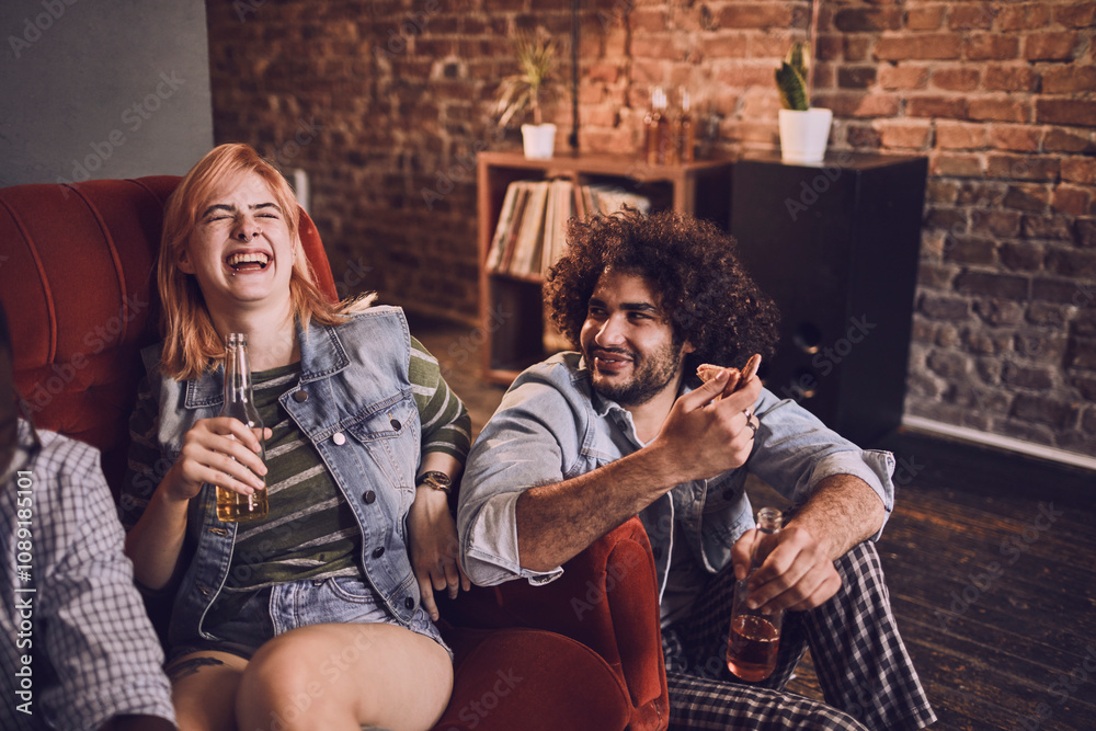 Friends laughing and having fun on a couch at a bar Friends laughing and having fun on a couch at a bar
