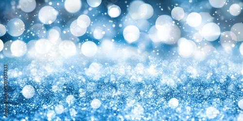 Sparkling snowflakes scatter across a vibrant blue backdrop, reflecting light in countless directions. This winter wonderland captures the essence of a serene, chilly day filled with enchantment