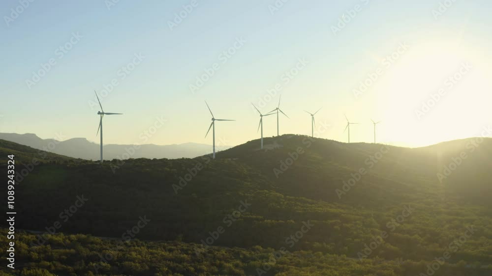 Aerial shot of wind turbines turning at sunset in unspoilt nature, Provence, France Aerial shot of wind turbines turning at sunset in unspoilt nature, Provence, France