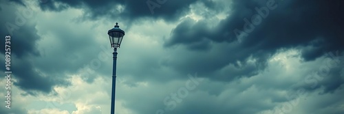 Blue street lamp standing under a dark and stormy cloudy sky, cloudy, dark