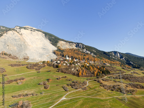 Aerial view of mountain village of Brienz Brinzauls in the Swiss Alps with rockfall in the background on a sunny autumn day. Photo taken November 15th, 2024, Brienz Brinzauls, Switzerland.