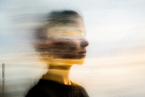 Blurry profile of person, abstract, motion, surreal effect.
