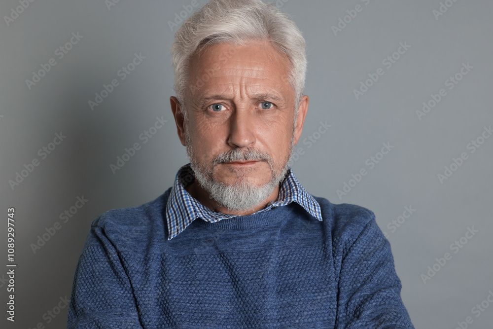 Portrait of senior man on grey background Portrait of senior man on grey background