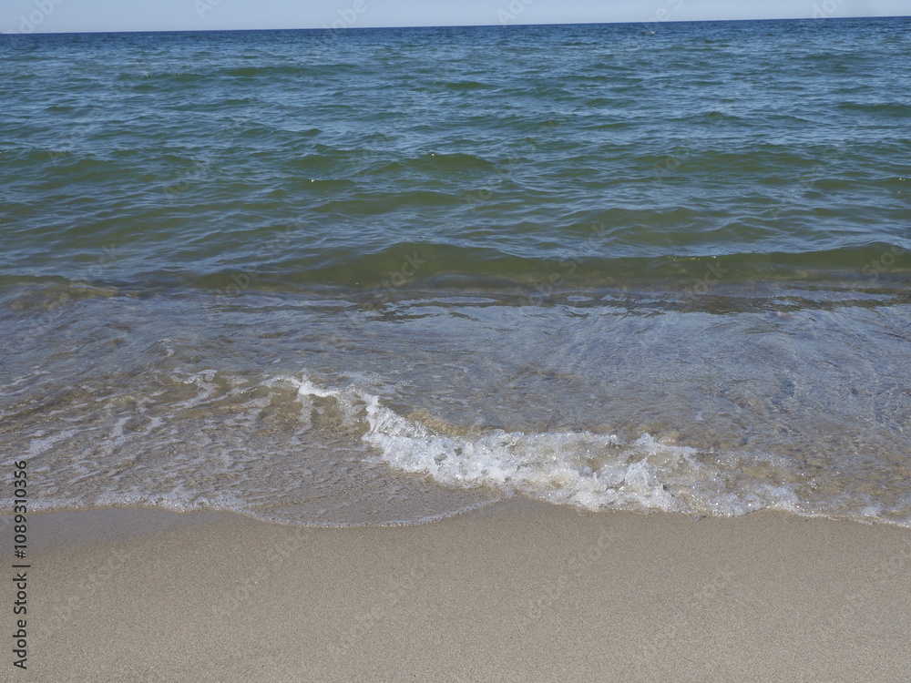 Calm sea with a clean sandy beach under a clear sky Calm sea with a clean sandy beach under a clear sky
