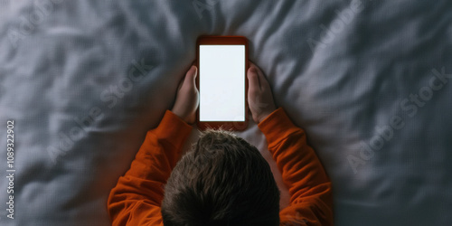 Cyberbullying abuse concept. child curled up on bed, illuminated by phone screen glow