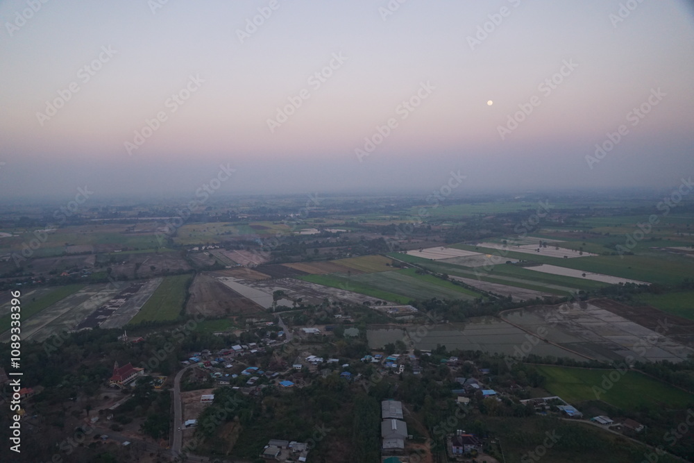 Fototapeta premium Aerial view of agricultural fields at dusk rural area photography calm environment scenic perspective nature's beauty