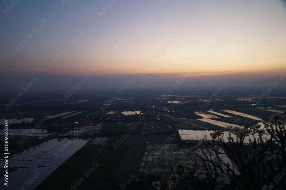 Sunset over rice fields agricultural landscape aerial view tranquil evening nature's beauty serene environment for relaxation
