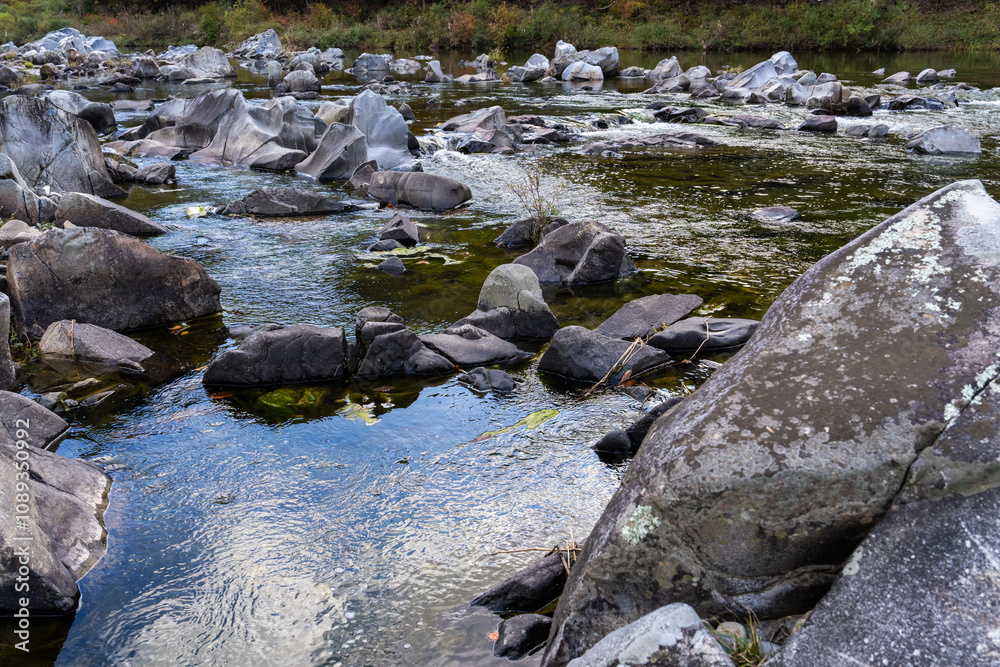 rocks and flowing stream in the autumn valley rocks and flowing stream in the autumn valley