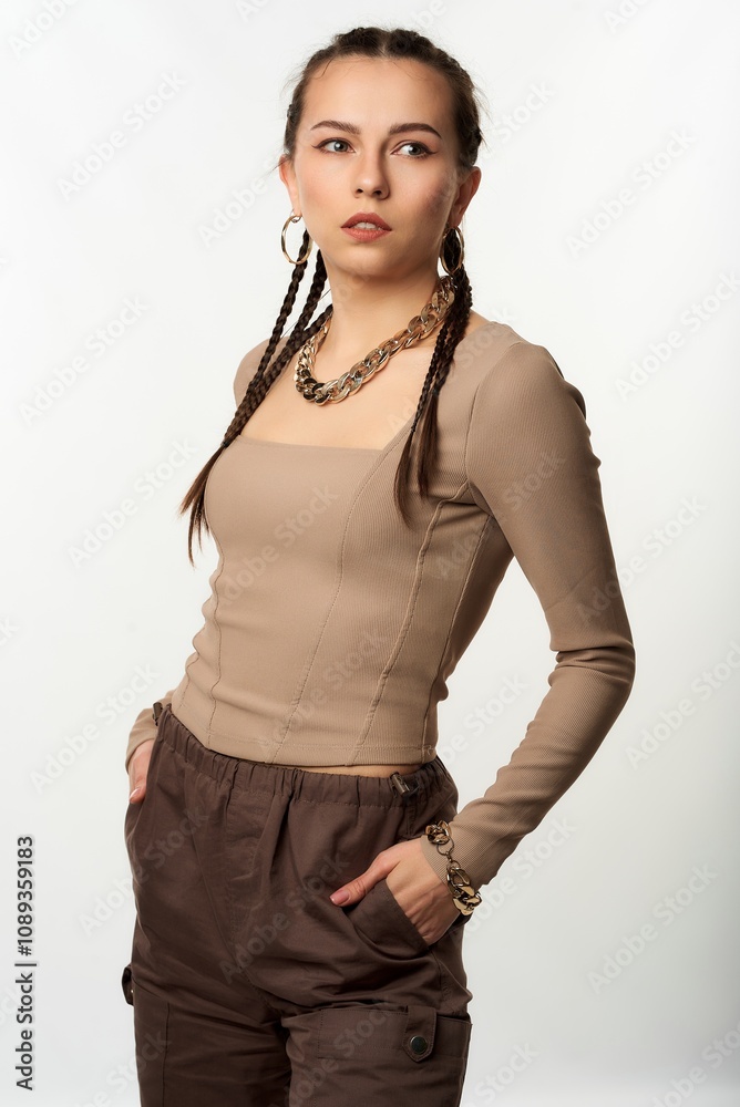 A girl poses in a studio against a white background. A girl poses in a studio against a white background.