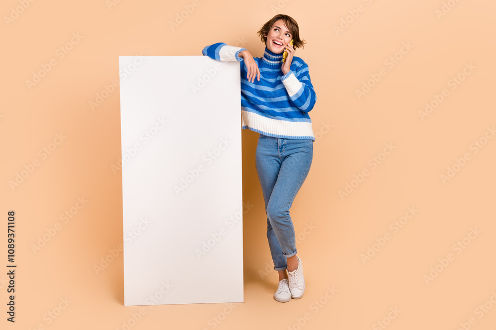 Full length photo of young girl conversation call phone near smartphone display application for communication isolated on beige color background Full length photo of young girl conversation call phone near smartphone display application for communication isolated on beige color background