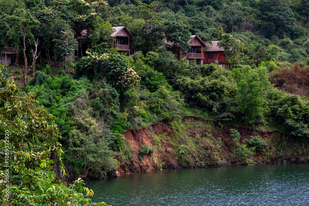 Fototapeta premium A view other cottages and river from a cottage of a resort