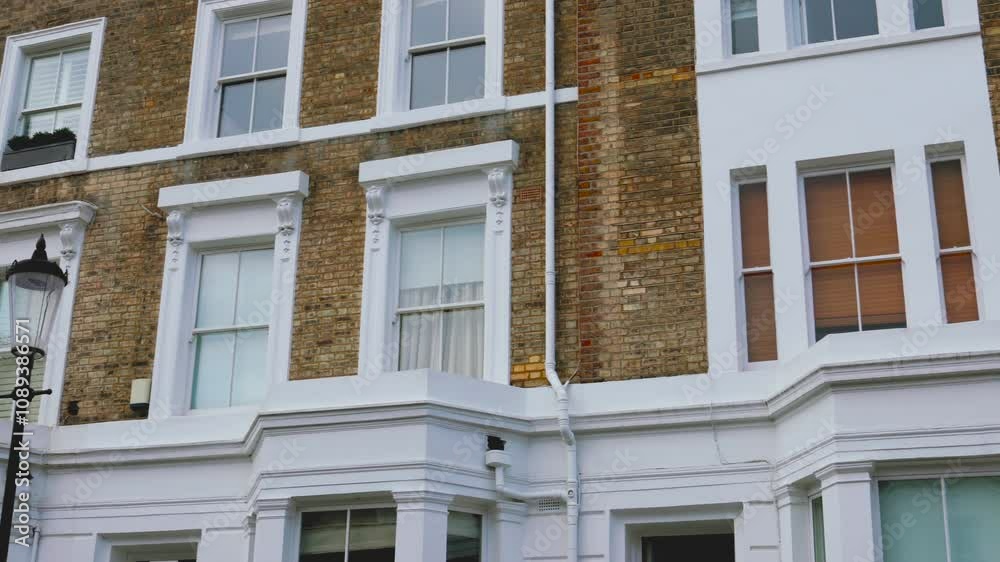 Georgian London townhouse facade of a building with windows, yellow brick house terrace Georgian London townhouse facade of a building with windows, yellow brick house terrace