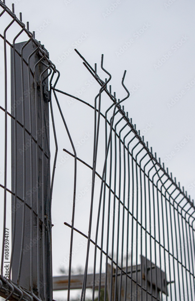 A fence with a broken section is shown A fence with a broken section is shown