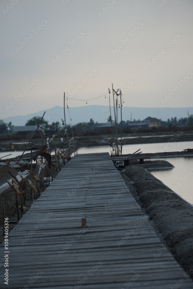 Obraz premium Serene dock at dusk tranquil waterfront photography natural landscape side view peaceful reflection