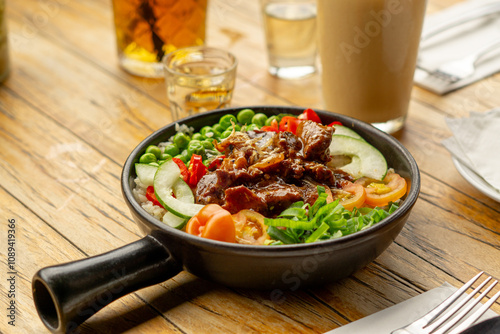 Beef Black Pepper Poke Bowl served on the table with Cappuccino and Iced Tea