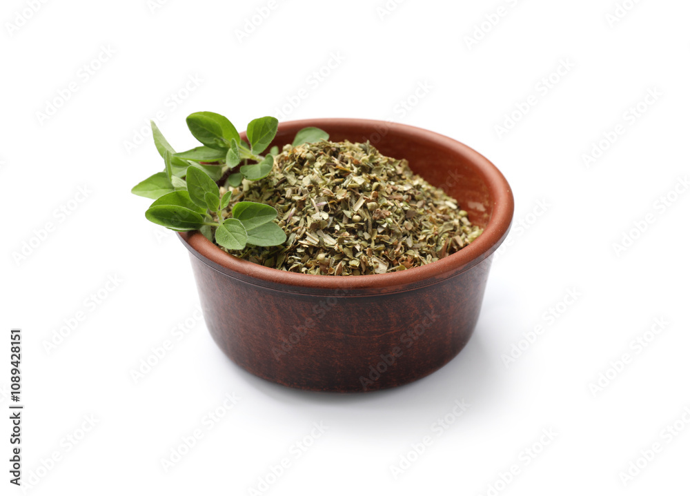 Dried oregano in bowl and green leaves isolated on white Dried oregano in bowl and green leaves isolated on white