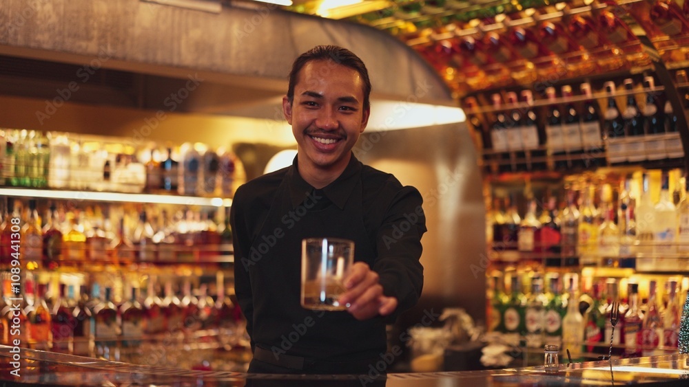 Smart Asian bartender using stirring mixed alcohol syrup into glass with ice for on the rock served mixing looking camera zoom out special refresh cocktail nightlife mixology at nightclub. Vinosity. Smart Asian bartender using stirring mixed alcohol syrup into glass with ice for on the rock served mixing looking camera zoom out special refresh cocktail nightlife mixology at nightclub. Vinosity.