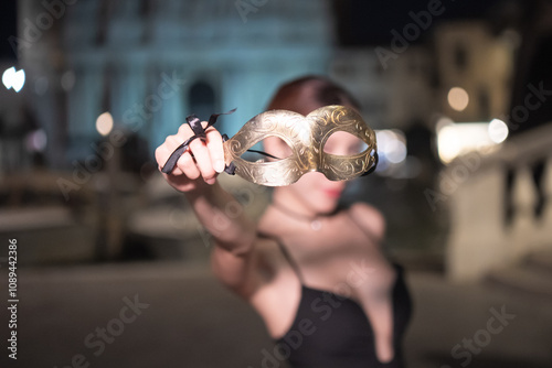 Woman with carnival mask night view of ponte degli scalzi in Venice, Italy. photo