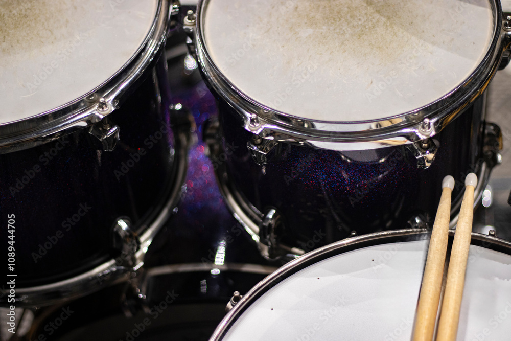 Drums and drum sticks in studio with no people.