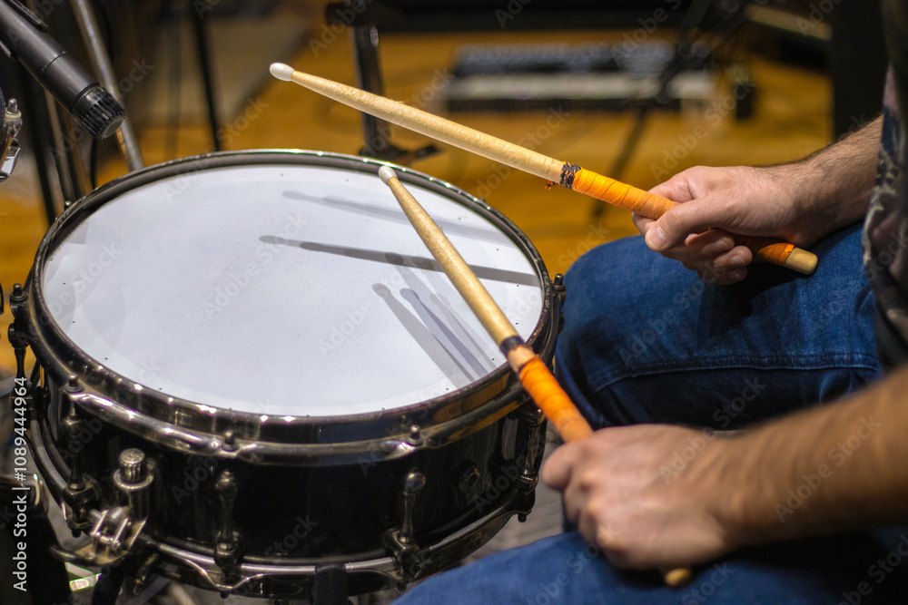Fototapeta premium Cropped picture of drummer playing drums in studio.