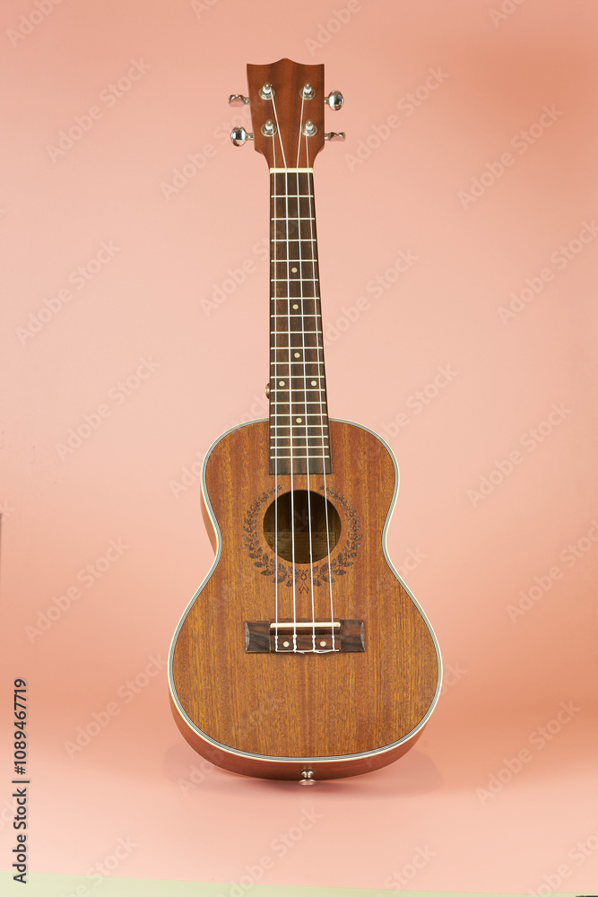 Fototapeta premium Ukulele. Hawaiian instrument that resembles a guitar but smaller in size with four strings that give it a unique sound.
