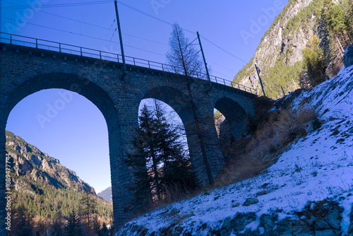 Railway stone viaduct between Swiss mountain village of Bergün and railway station of Preda of narrow gauge railway line on a sunny autumn day. Photo taken November 15th, 2024, Albula, Switzerland. photo