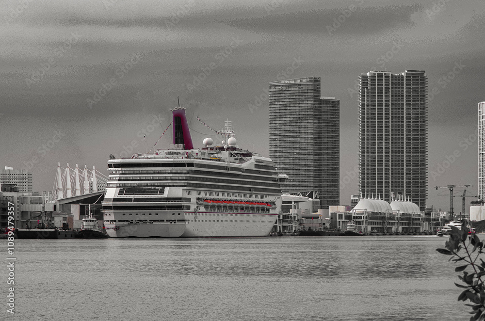 Fototapeta premium Family cruiseship or cruise ship ocean liner Victory during sunset and twilight in port of Miami, Florida with skyscraper skyline ready for Caribbean cruising