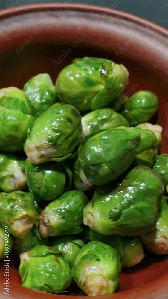 Brussels sprouts close up cooking in a frying pan for breakfast. Healthy food and green vegetables for better health and fitness diet. Cooking process in a frying pan in the kitchen Brussels sprouts close up cooking in a frying pan for breakfast. Healthy food and green vegetables for better health and fitness diet. Cooking process in a frying pan in the kitchen