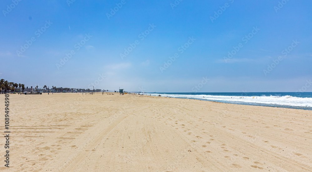 California USA. People on sandy Venice beach. Pacific ocean coastline Los Angeles. Blue sky California USA. People on sandy Venice beach. Pacific ocean coastline Los Angeles. Blue sky