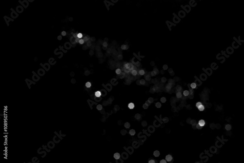 White gray blurred bokeh lights on black background. Glitter sparkle stars for celebrate. Overlay for your design