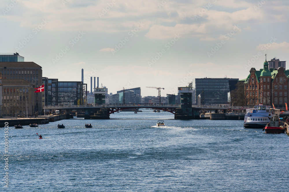 Naklejka premium Local people riding bicycles on Knippelsbro Knippel bascule bridge across the Inner Harbour on Christianshavn, Copenhagen, Denmark