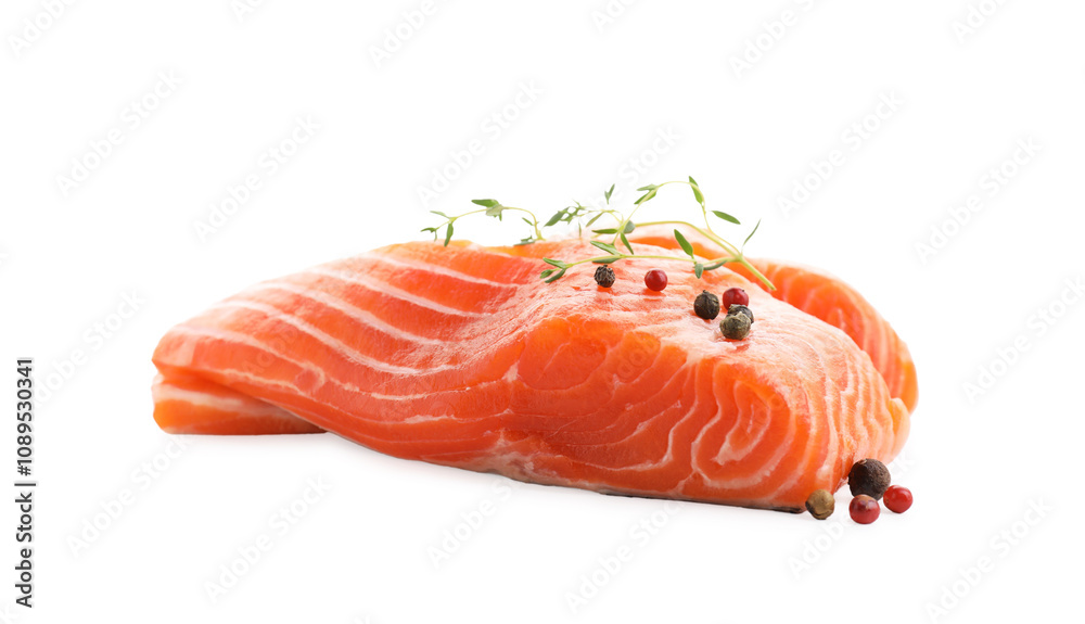Pieces of fresh salmon, peppercorns and thyme isolated on white