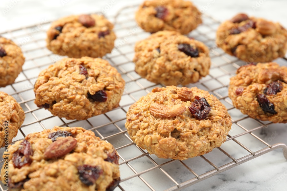 Delicious oatmeal cookies with raisins and nuts on white marble table, closeup Delicious oatmeal cookies with raisins and nuts on white marble table, closeup